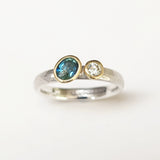 Offset sapphire and diamond ring