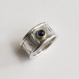 Wide wavey or spotty ring with stone