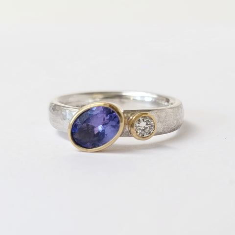 Offset tanzanite and diamond ring