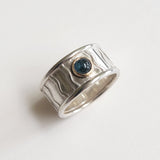 Wide wavey or spotty ring with stone